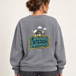Model wearing the Saucisse Dachshunds Are the New Influencers Mineral Grey sweater, rear view in a warm neutral studio