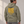 Man wearing the Saucisse Long Walk Sundays, Fuel Your Mondays hoodie in Almond Green, shown from the back in a studio.