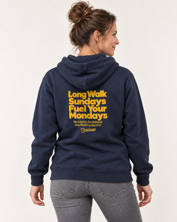Woman wearing the Saucisse Long Walk Sundays, Fuel Your Mondays hoodie in Navy, shown from the back in a studio.