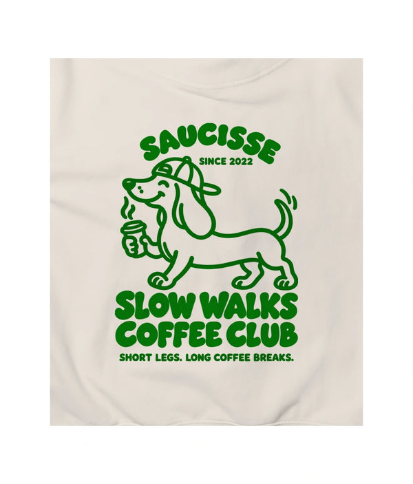 Close-up of the green Slow Walks Coffee Club back print on the Ivory Saucisse hoodie, showing the fabric texture