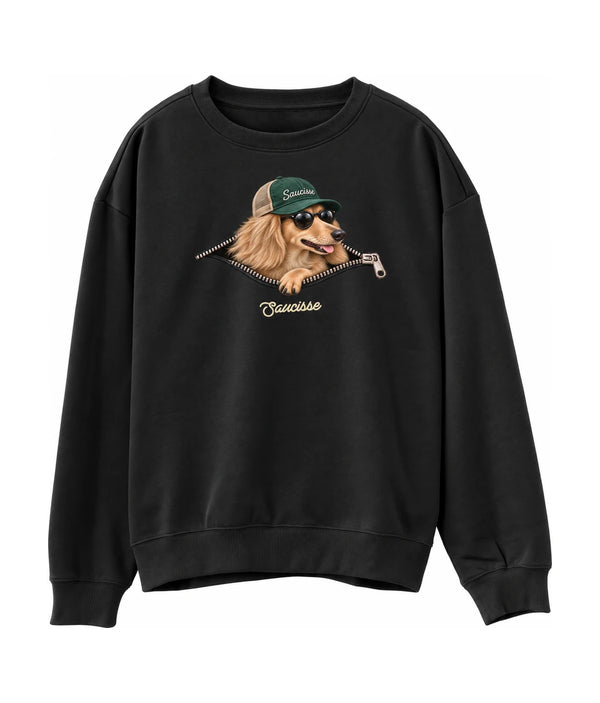 Saucisse Unzipped long-haired unisex sweater in Black, front view showing a long-haired dachshund in a green cap and sunglasses emerging from a printed zip.