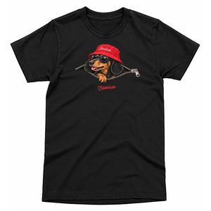 Front view of the Black Saucisse Unzipped Short Haired unisex T-shirt, with a dachshund in a red Saucisse bucket hat and sunglasses peeping through an illustrated zip and a red Saucisse signature.
