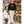 Woman wearing the Saucisse Unzipped wire-haired unisex sweater in Black while walking a wire-haired dachshund through a flower market.