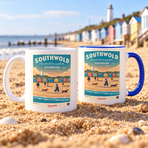 White and blue Southwold Sausage Dog Walk 2026 mugs on a sandy British beach with beach huts