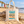 Natural Raw Southwold Sausage Dog Walk 2026 tote bag on a sandy British beach beside beach huts