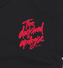 Saucisse Too Dachshund to Apologise black Tshirt, front coral print close-up.