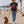 Saucisse Too Dachshund to Apologise black Tshirt, back lifestyle photograph with woman and dachshund.