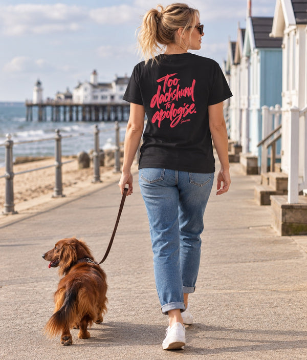 Saucisse Too Dachshund to Apologise black Tshirt, back lifestyle photograph with woman and dachshund.
