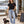 Saucisse Too Dachshund to Apologise black Tshirt, front lifestyle photograph with woman and dachshund.