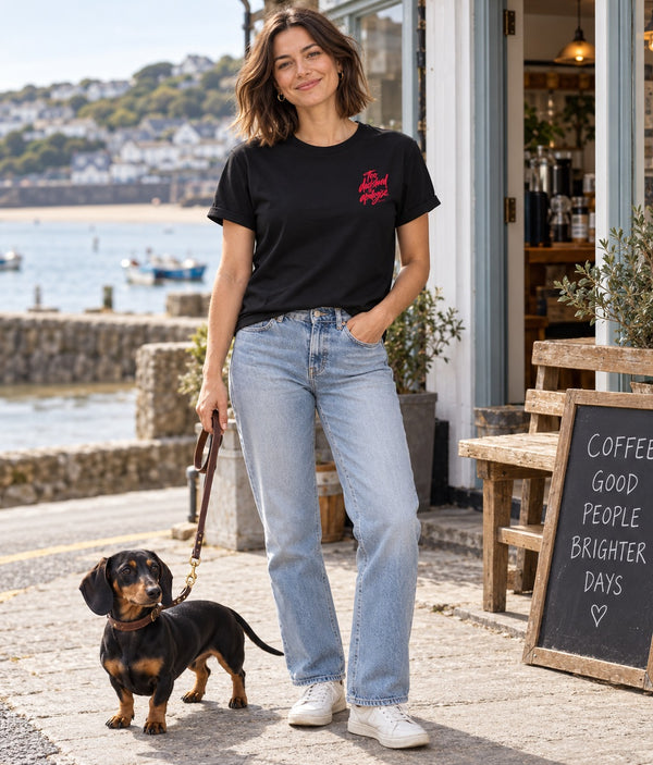 Saucisse Too Dachshund to Apologise black Tshirt, front lifestyle photograph with woman and dachshund.